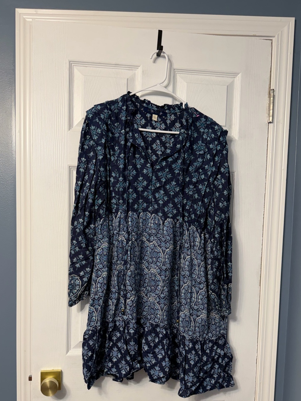 Blue Rain casual, bohemian-style minidress features long sleeves, a ruffle split